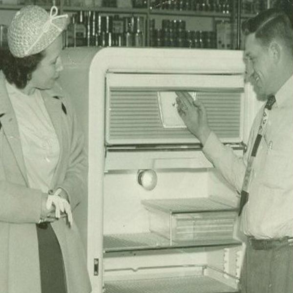man selling woman refrigerator in 50s